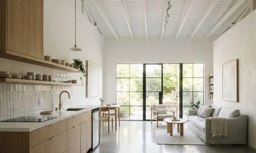 Converted garage studio with a wood kitchen and glass doors